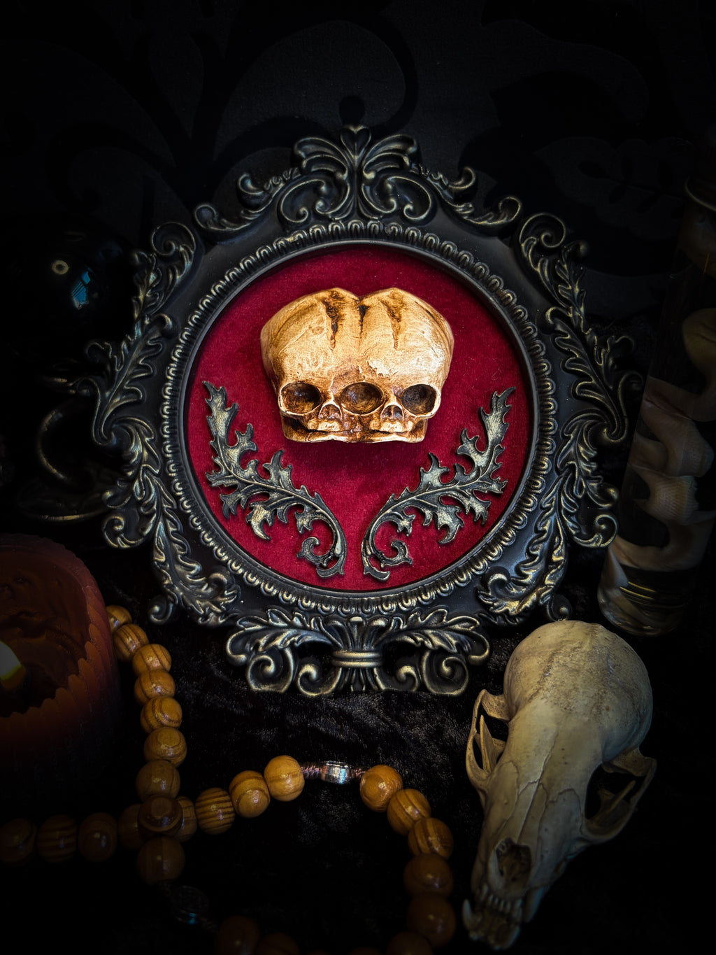 Handmade gothic shadowbox with conjoined skulls, ornate frame, black velvet lining — dark wall decor