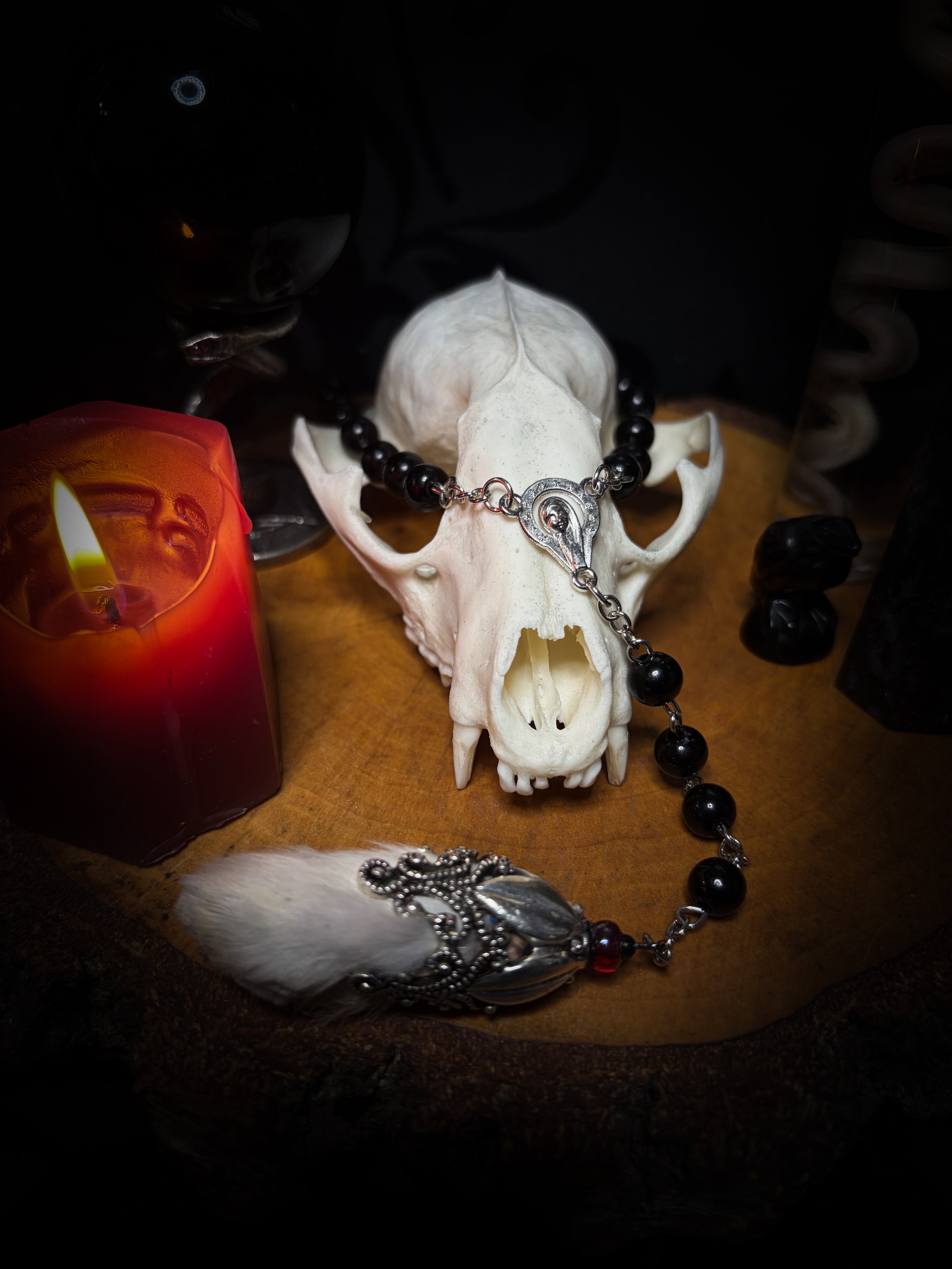 Rabbit Foot Rosary | Necklaces — handmade dark necklace with real preserved white rabbit foot, partial rosary chain, carnelian beads and ornamental metal detail, macabre alternative jewellery