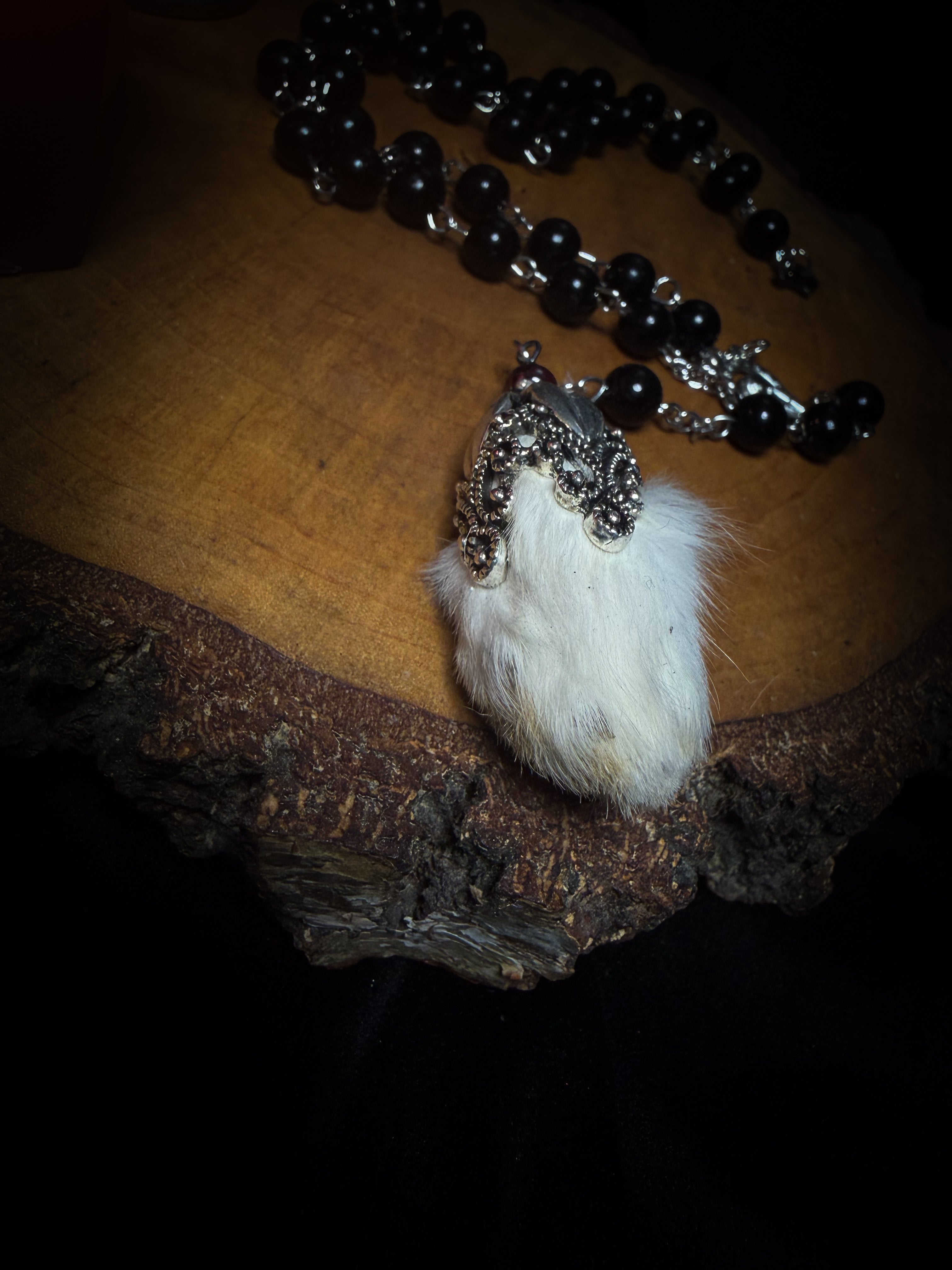 Rabbit Foot Rosary | Necklaces — handmade dark necklace with real preserved white rabbit foot, partial rosary chain, carnelian beads and ornamental metal detail, macabre alternative jewellery