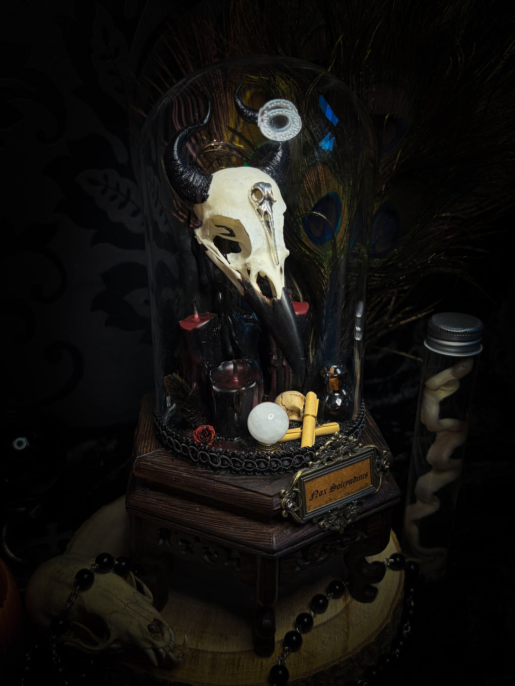 Nox Solitudinis — handmade gothic display with crow skull, hand-carved horns, crystal orb, vampire candles, wax rose and black iridescent sand. Morbid Oddities.