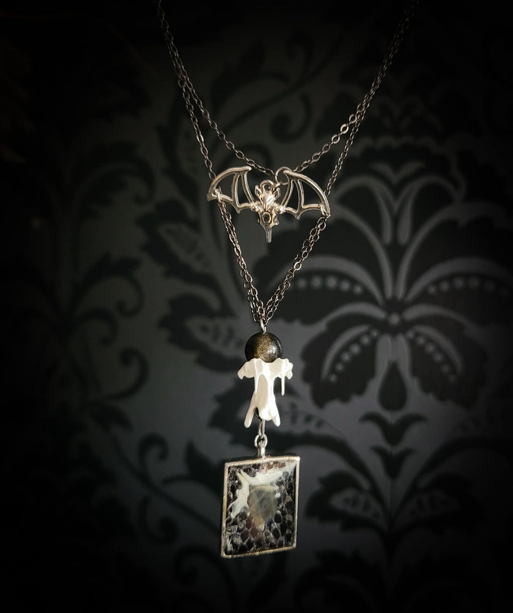 Handmade gothic necklace — labradorite stone and mouse jaw in resin pendant, snake skin background, vertebrae connector, metal bat charm