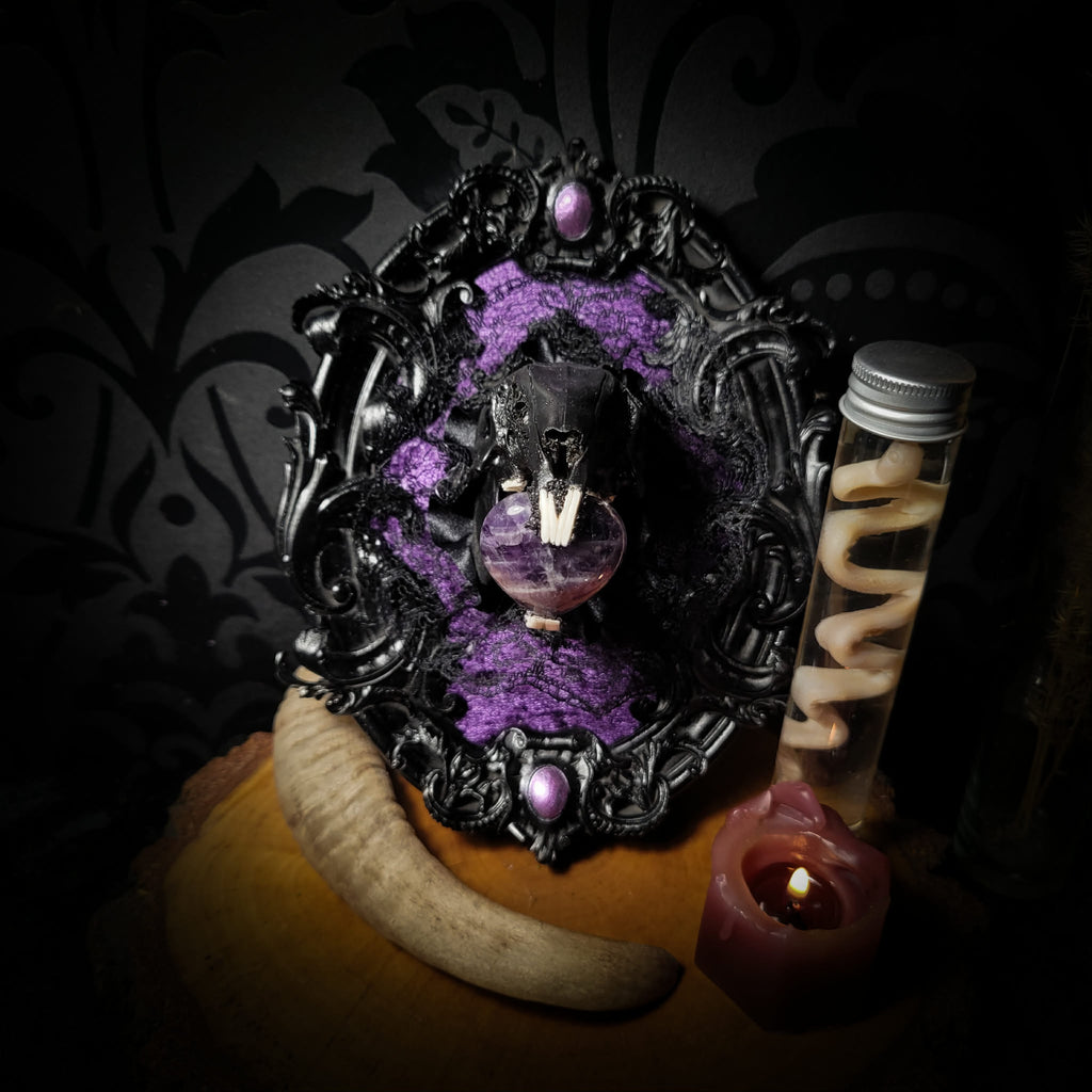 Handmade gothic shadowbox — black rabbit skull with amethyst heart, crushed purple velvet, ornate baroque frame, 19x15cm