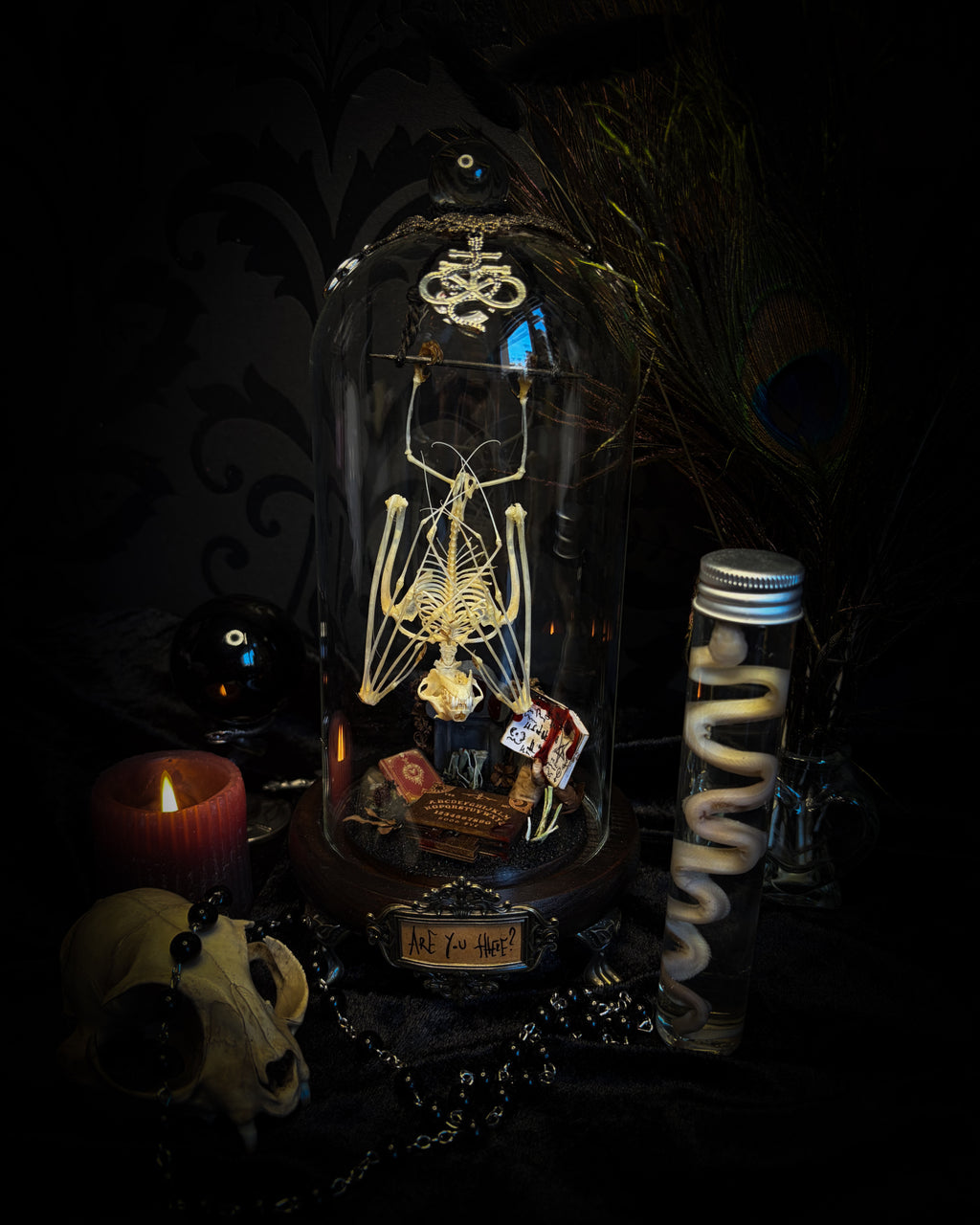 Handmade gothic occult display — bat skeleton in glass dome with Leviathan sigil, cemetery vignette with ouija board and necromancer book, 12x24cm