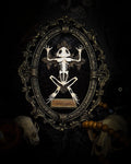 Witch's Familiar | Gothic — real preserved toad skeleton in hand-cast antique gold baroque oval frame on black crushed velvet, hand-painted cross and antiqued plaque, Morbid Oddities

