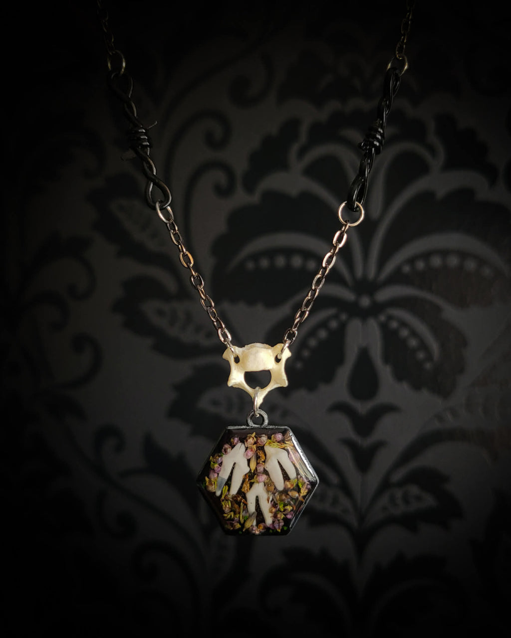Handmade gothic necklace — real fox teeth and dried heather flowers in hexagonal resin pendant, vertebrae connector, metal bat charm
