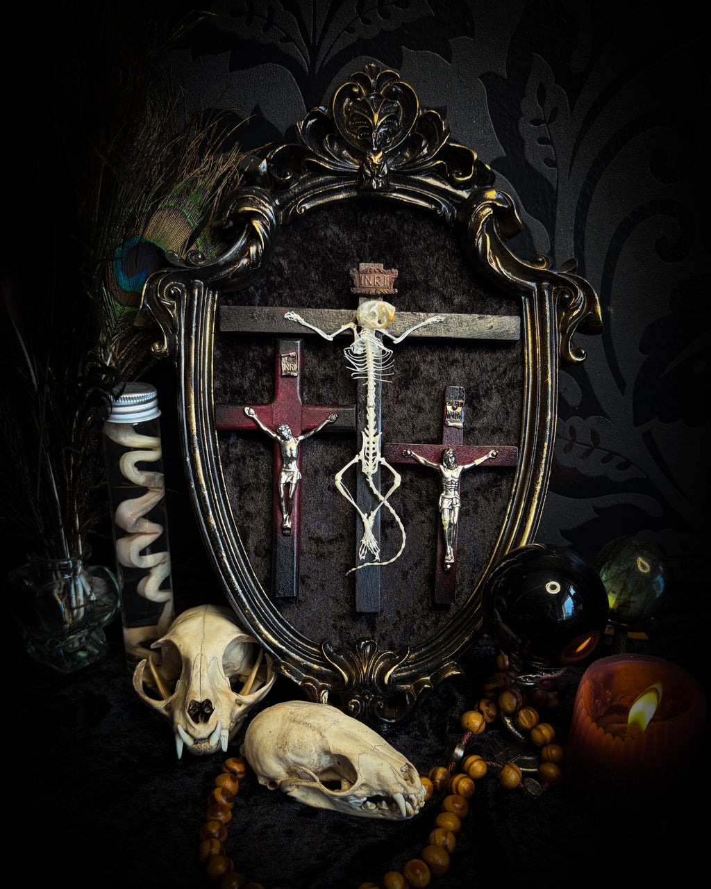 Golgotha | handmade occult relic with real mouse skeleton on three crosses with INRI inscription, cast and painted black and gold frame, black velvet backing | Morbid Oddities
