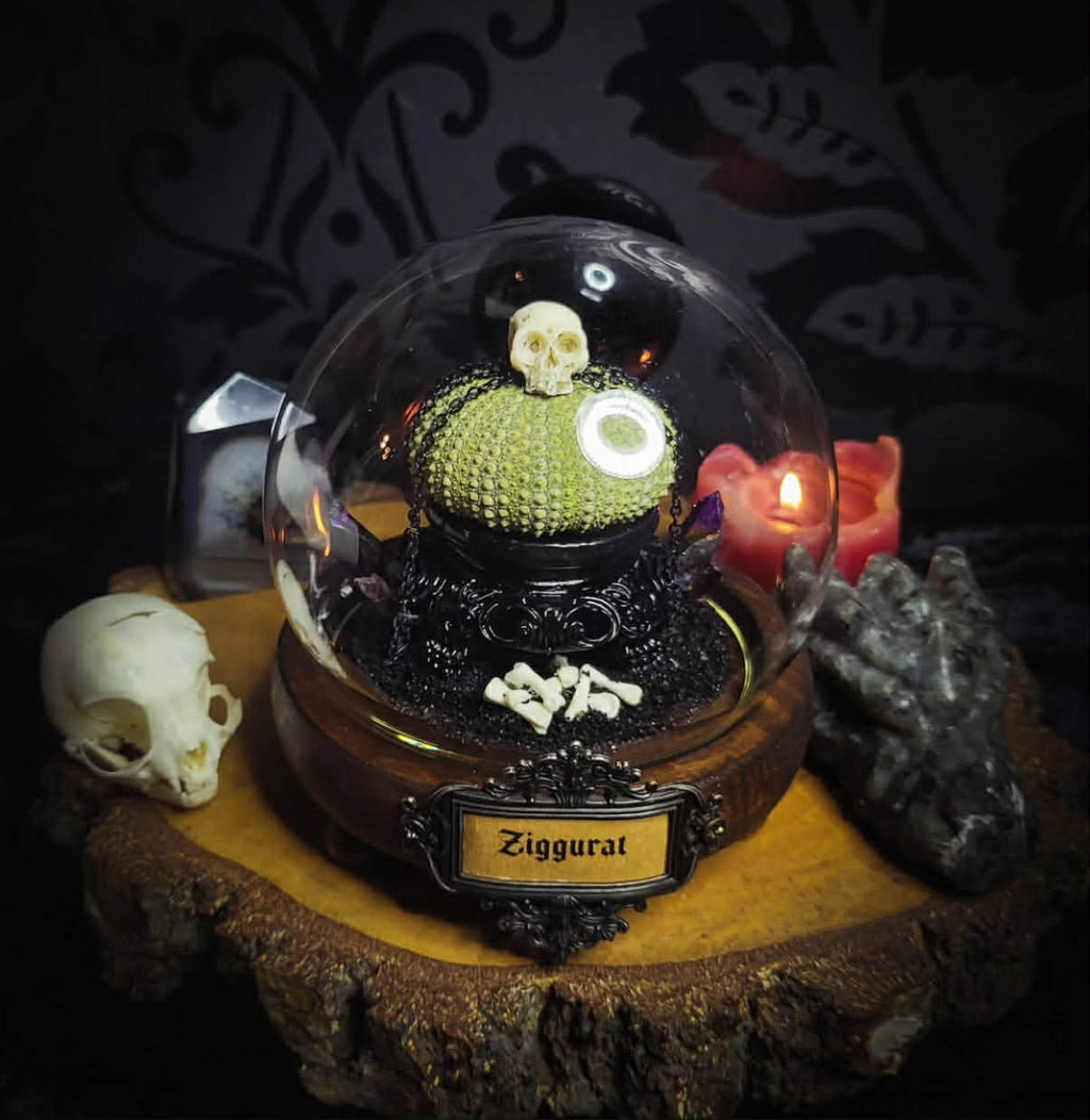 Siggurat | Occult — handmade gothic altar piece with ziggurat-inspired centerpiece, real bone elements, sea urchin skeleton, decorative crystals and chains under glass dome on hand-painted wooden base, 10x10cm